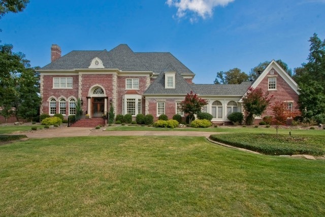 Stately Georgian Estate, on the Chenal Country Club’s “Founders Course” This recently updated home features an exquisite principal residence and a separate guest house. From the moment you enter you are captivated by sweeping views of the water way and golf course. The interior is adorned with ornate millwork, arched entries, gleaming hardwoods and expansive windows. Extensively updated makes this the perfect family home. A change in the owners plans makes this the best buy in Chenal. Easy to Show!!