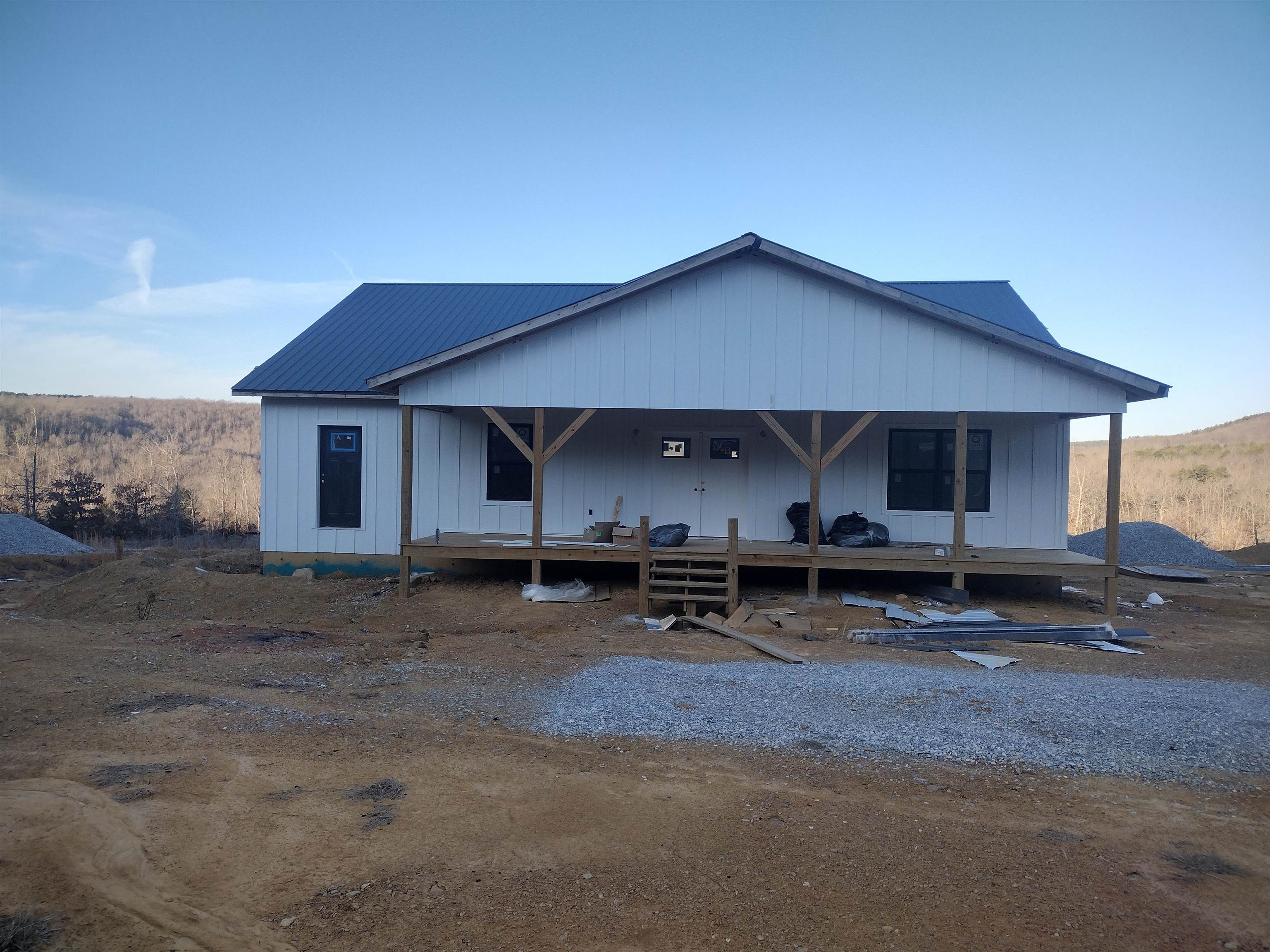 New unfinished home this home is wired plumbed has sheet rock installed and come with almost all material to finish comes with new Frigidaire appliances. Double gas range drawer microwave full size refrigerator with freezer on side, dishwasher, tankless water heater and Cali flooring 50-year warranty. Has great views and more land can be purchased at additional cost .