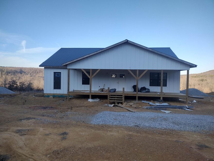New unfinished home this home is wired plumbed has sheet rock installed and come with almost all material to finish comes with new Frigidaire appliances. Double gas range drawer microwave full size refrigerator with freezer on side, dishwasher, tankless water heater and Cali flooring 50-year warranty. Has great views and more land can be purchased at additional cost .
