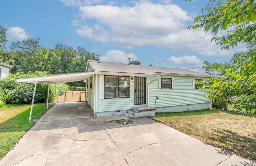 Welcome to this wonderfully updated 3-bedroom, 1-bath residence that perfectly blends classic character with modern updates. Step inside to discover original hardwood floors that add warmth and timeless appeal throughout the living spaces. The updated kitchen and bathroom offer contemporary finishes, ensuring both style and functionality.  Custom wainscoting in the bedrooms provides a touch of elegance, while abundant storage makes it easy to stay organized. Situated on a generous corner lot, this home features a large, fully fenced backyard—ideal for entertaining, relaxing, or gardening. Enjoy sunny afternoons on the patio, convenient covered parking with the carport, and the added bonus of a mature mulberry tree. (Yes, it really does produce jam-worth berries!)  This home is move-in ready and offers the perfect combination of comfort, charm, and outdoor space. Don’t miss the opportunity to make it yours!   *Agents see remarks
