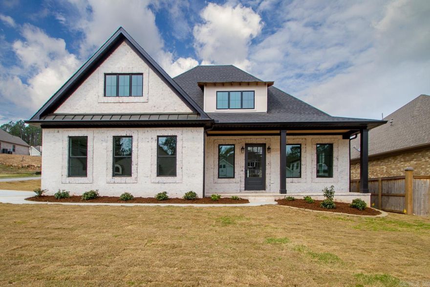 Welcome to this stunning home in the highly sought-after Ison Creek community. Built in 2020, this energy efficient one owner 3BDR, 2.5BA home offers approximately 2,544 sq ft of thoughtfully designed living space on a 0.22 acre lot. The bright interior features 12' ceilings with high-end details throughout and an oversized black granite island with bar seating that anchors the kitchen, complemented by white quartz countertops throughout the home. The kitchen includes Frigidaire appliances and the washer and dryer convey at no value while the cozy fireplace creates a warm focal point for gathering in the living area.  The spacious primary suite features dual vanities, soaking tub, separate glass-encased tile shower and a private water closet. The additional full bath offers dual sinks and a tub/shower combo. Hardwood, carpet and tile flooring run throughout the home. Enjoy covered front and back porches with access from the living area and the primary bedroom, a two-car garage, and a privacy-fenced backyard.  Ison Creek is known for its unique charm, with a single entrance crossing a creek and a close-knit, family-friendly atmosphere where neighbors truly know one another.