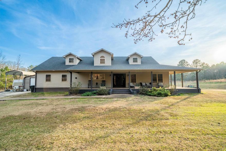 Stylish, classy, beautiful countryside living at it's best! This gorgeous home with 18' ceilings, designed concrete flooring, large rock fireplace, open floor plan on the inside, then opens up to a dreamy outdoor kitchen area with another fireplace and a tv for entertaining guest who can also enjoy the welcoming in-ground heated, saltwater pool. The  heated/cooled detached garage and is the perfect work space,  where the owner has rebuilt many beautiful classic cars or for any other workshop area you may want.  All of this sits on beautiful 2 acres where you can enjoy other outdoor activities or a place to park your boat, rv or any other toys.  The back yard is fenced in to keep your fur babies safe, yet they have plenty of room to play.