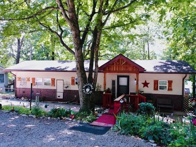 REDUCED $25,000! Seller is offering $1,000 towards Buyers closing costs with accepted offer! This Cute Cozy Cottage has a large 23 foot tongue groove knotty pine porch that expands whole length with fantastic views to enjoy your coffee and contemplation. Remodeled kitchen with stainless steel appliances. New floors throughout. Open concept kitchen and living room with lake view. Master bedroom has room for a Queen sized bed and large dresser. Master bathroom has a 12 foot jacuzzi tub with lakeview window and a big walk in shower with 4 foot vanity. The 2nd bedroom is complete with a half bath. This home also features new 6 panel doors and exterior doors, windows, low maintenance vinyl siding, aluminum fascia, cedar covered porch, exterior stairs to lake, deck with pergola at lake front with tiki bar and 10x12 shed, and fire pit. The property has 100 feet of lake frontage and a dock that is complete with storage seat for fishing equipment. The front of the home is complete with a flower garden, seating area, circular drive, and 30 amp RV plugin! This is a Must See!! Welcome to LAKE MIRANDY!