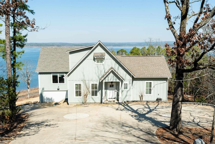 Eden Isle - LAKEFRONT HOME!  Located at the very northern end of Eden Isle, and built in 2017, this beautiful lakefront home has LOTS of living space!  Walls of glass overlooking Greers Ferry Lake from almost every room!  The newly added greatroom has very tall ceilings, glass on two sides of the room with corner fireplace, large deck with glass railings, kitchen with stainless appliances, island with breakfast bar, gas cooktop, coffee bar with sink and wine cooler, and half bath for main loving area.  The primary bedroom has a very large closet, beautiful lake views and private deck and lovely ensuite bath with walk-in shower, separate jet-tub and double vanity.  Covered outdoor dining, outdoor kitchen area, sunken hot tub on deck.  3-car garage is perfect for lots of lake toys!  Easy walk to the lake, small storm cellar.  Some of the prettiest views on the island!
