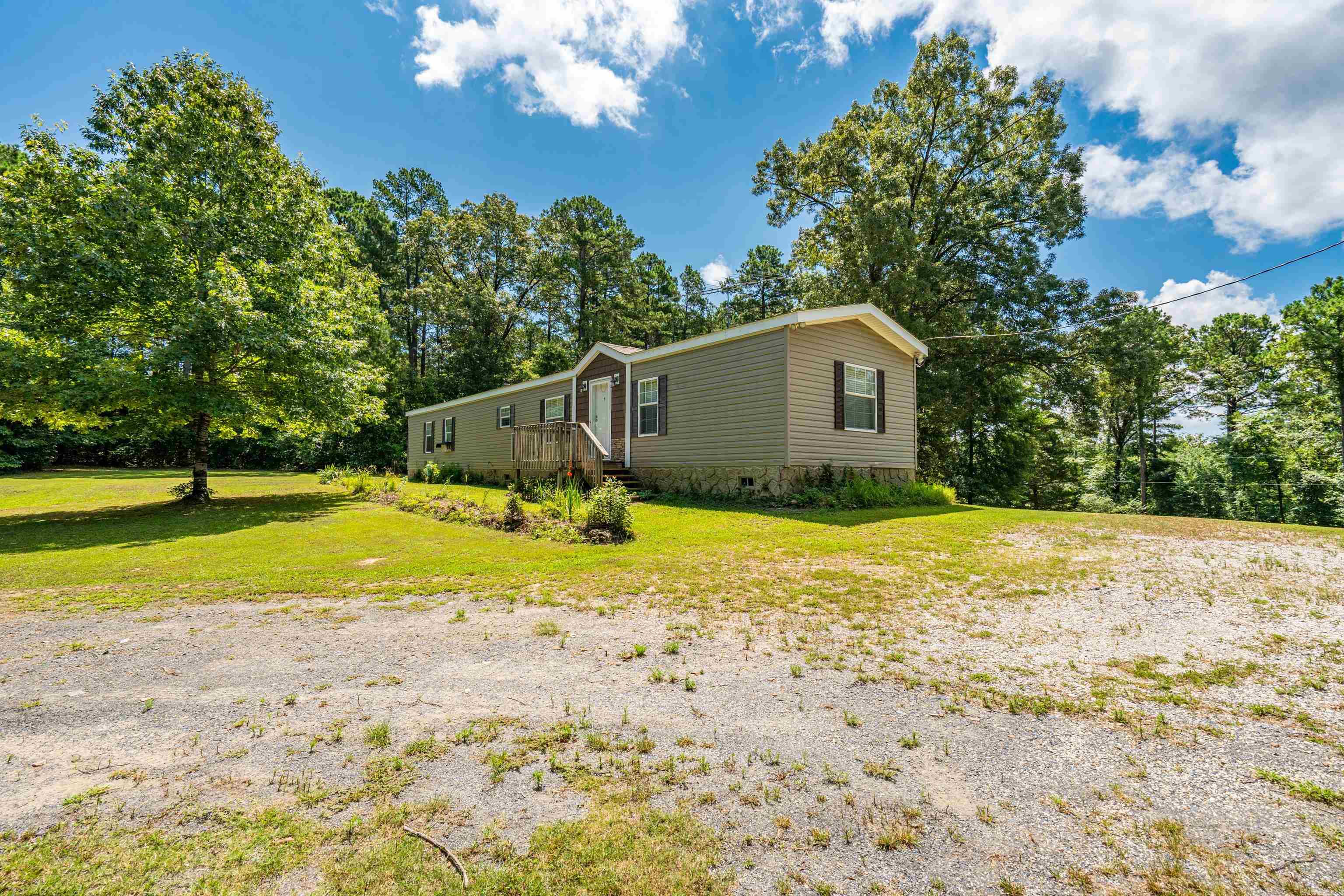 Discover peace and privacy on this beautiful 3-acre property! Tucked away on a private drive, this well-maintained 2-bedroom mobile home is in immaculate condition and offers a serene, park-like setting. Enjoy the comfort of outdoor living with a spacious yard, outside storage building, and a storm cellar for added security. Whether you're looking for a weekend escape or a full-time residence, this property is move-in ready and perfectly suited for quiet country living.