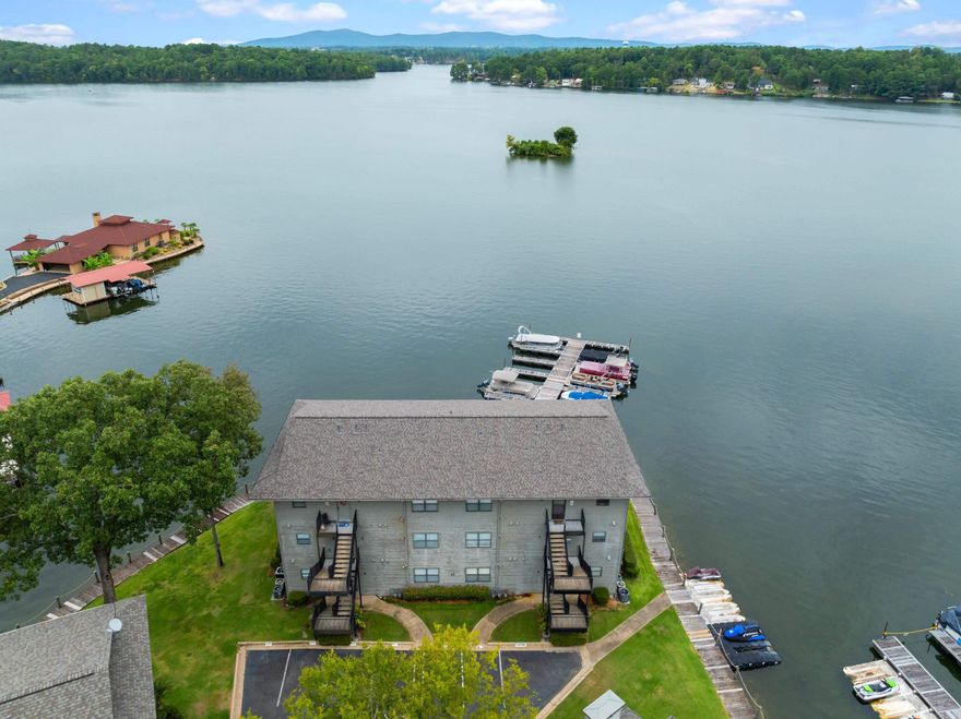 Panoramic views of Lake Hamilton allow you to enjoy sunrise AND sunset on the wrap around deck. 1360 sq ft make this 2nd floor 2 bedroom fully furnished condo larger than most other units in Farr Shores. Enjoy easy entertaining from the large kitchen that is open to the freshly painted living room. The primary bedroom has a picture window and access to the deck plus a large walk-in closet a huge en-suite bathroom.  The 2nd bedroom is large enough for a queen bed plus a bunk. Your boat slip is just steps away and there is a PWC dock as well with this unit. Farr Shores allows nightly rentals and has a pool, tennis courts and private boat ramp. Easy drive to Garvan Gardens, Oaklawn, Magic Springs, Bathhouse Row, National Park trails and Mountain Tower