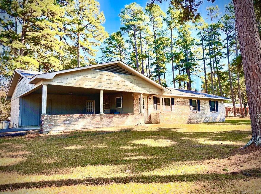 LISTEN TO THE PINES outside this well-built and well-maintained 3 bedroom, 2 bath ranch home on 2.55 acres! This home is located on the ridge near Bethesda Springs just minutes from WOLF PEN GAP TRAILS and Mena.  The large carport is perfect for outdoor entertaining and has a room that can be used as a 4th bedroom or storage as well.  Updates include new doors, new roof, and a new wood stove! Amenities include a breakfast bar, dishwasher, microwave, stove, disposal, washer, dryer, and a Stainless Steel refrigerator with ice maker.  In the primary bedroom the Bathroom has been recently updated with a beautiful tile shower for easy access and second bath has a nearly new walk-in-tub!  There is a 24x30 detached garage in back, and this home has both city water and a well.  The possibilities are endless. Most furnishes can convey for a turn key vacation rental with easy paved road access to the trails and Mena!