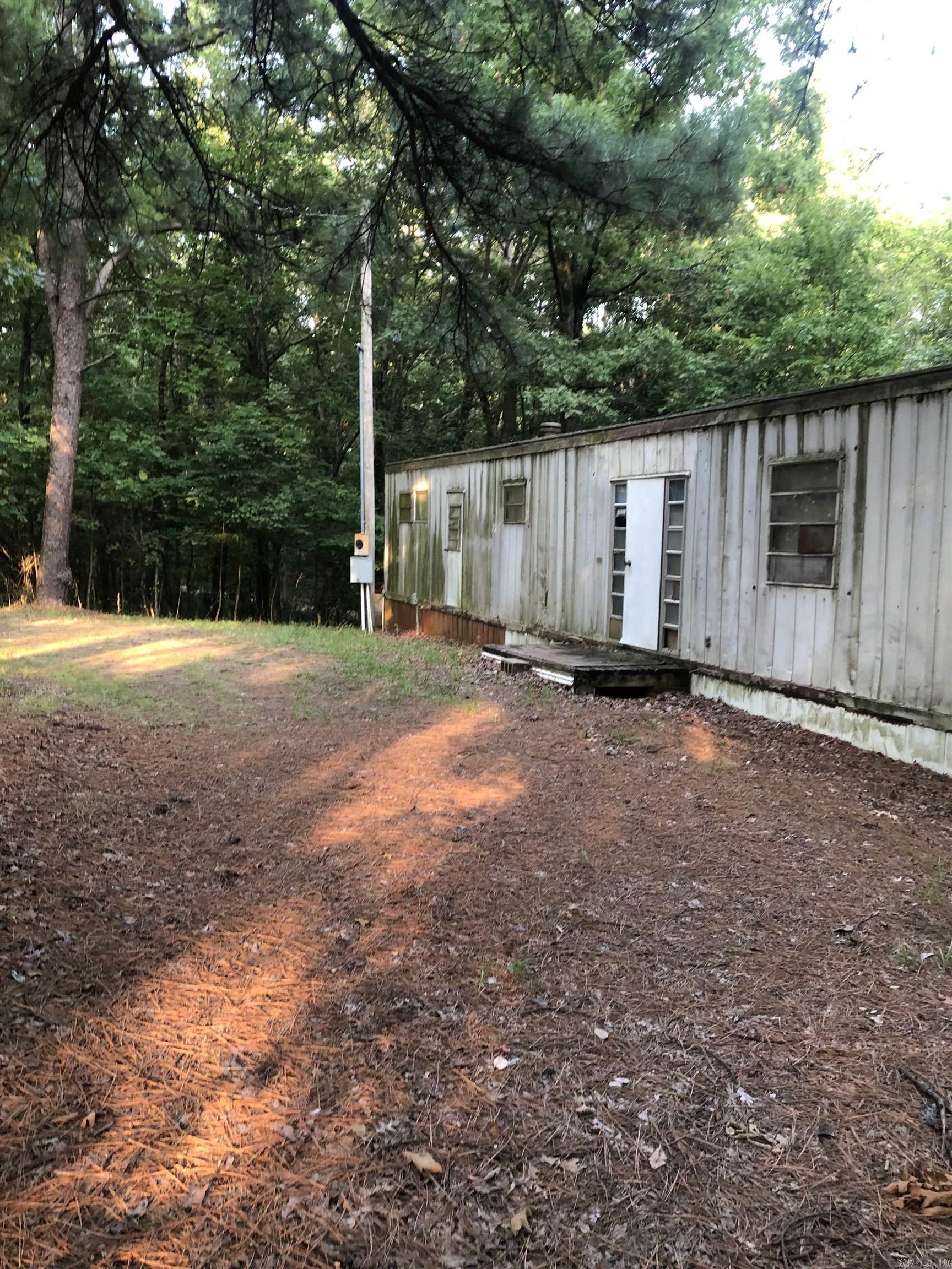 If your wanting OUTSIDE OF TOWN look at this lot for a potential purchase. While the mobile home does have potential for the right buyer you may want to put a new home on this lot. Lot is being sold AS-IS