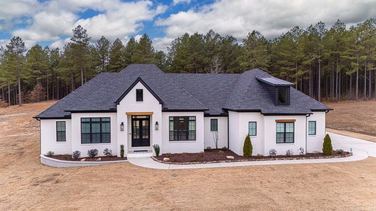 Pleasant Lake Estates offers a serene living environment with no SI taxes and no HOA dues, featuring a picturesque lake ideal for fishing. This beautifully decorated residence boasts 4 bedrooms, one being used as an office. Accompanied by two full bathrooms. The open floor plan showcases a brick-accented entrance to the kitchen, while the split bedroom plan provides added privacy. The expansive dining area and kitchen island, capable of seating four to five individuals, exemplify the home's entertainment potential. Additional features include stainless steel appliances, a beverage cooler, and an exceptionally large pantry with a convenient garage entrance. The electric fireplace, flanked by built-in cabinets, adds warmth and ambiance to the living space. One side of the residence features a spacious hall bath with a separate tub/shower area, while the primary suite boasts a standalone tub, separate tile shower, and ample closet space. The covered back porch, complete with a woodturning fireplace, and partially fenced yard provide the perfect setting for outdoor relaxation. SEE REMARKS