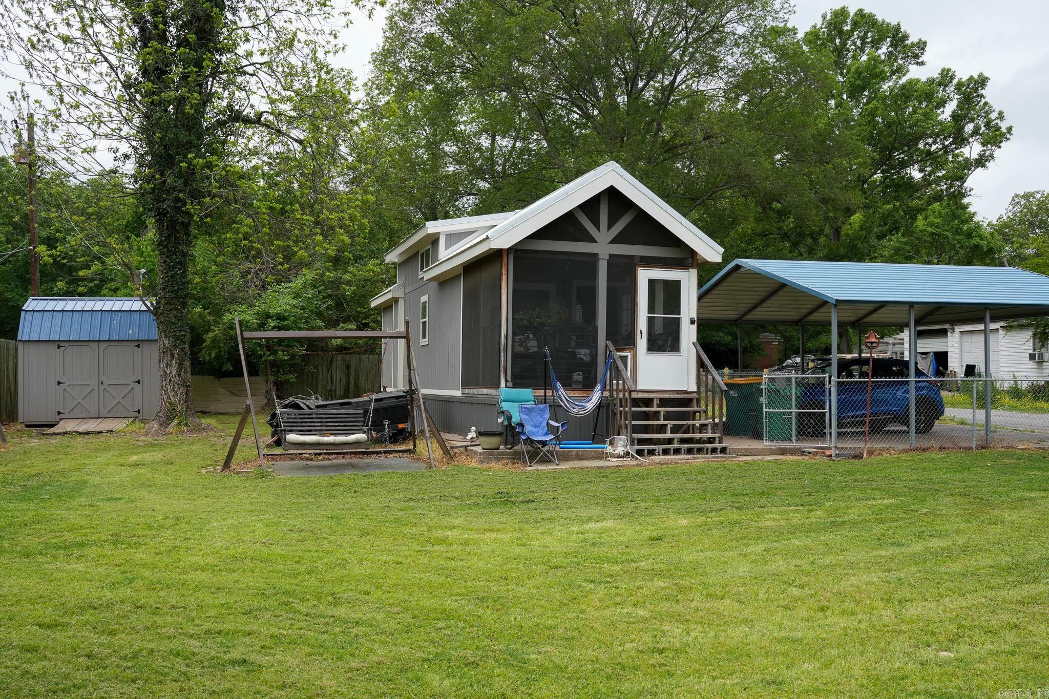Fully fenced , home sits on permanent foundation , Serene surrounding. the house features a screened front porch, living room with built in sideboard , Kitchen includes dishwasher, double sink . Washer and Dryer convey. Built in closet, Storage Loft There is storage shed outside.