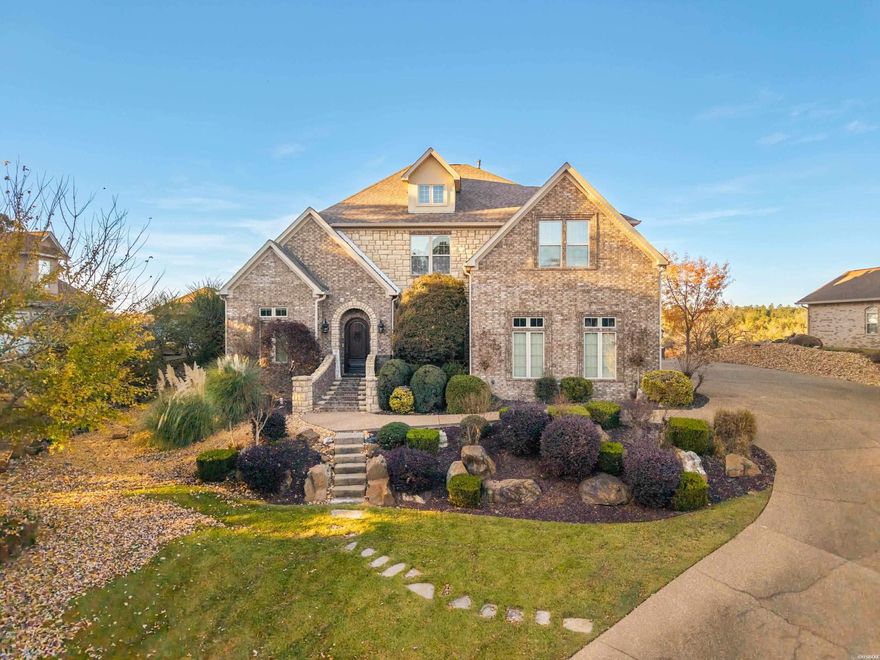 Welcome to your dream lakefront retreat in the prestigious gated community of Lake Forest Shores on iconic Lake Hamilton. This exquisite 4-bedroom, 3.5-bath home offers an exceptional blend of elegance, comfort, and modern convenience, all enhanced by year-round deep-water access, panoramic lake views, and access to the neighborhood boat launch. Designed to impress from the moment you step inside, the home features soaring 24-foot ceilings that fill the living spaces with natural light and frame the stunning water front scenery. The gourmet kitchen is a chef’s paradise, showcasing top-of-the-line Thermador appliances, custom cabinetry, and premium finishes that make both everyday living and entertaining a delight. Outdoor living is at its finest here, with three expansive lake-facing decks, each upgraded with brand-new Trex decking. These spaces provide ideal settings for hosting gatherings, enjoying morning coffee, or simply unwinding while surrounded by the tranquil beauty of the lake. A covered double boat dock with lifts and a double jet ski dock make time on the water effortless, while a convenient tram provides easy access to the shoreline.