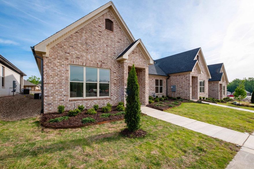Welcome to Edgewood, West Little Rock’s newest neighborhood where upscale living meets low-maintenance convenience. Built by Graham Smith Construction, this thoughtfully designed 3-bedroom, 2-bath attached home offers modern comfort with no yard work required, lawn care is included. Step inside to a bright, open-concept layout with designer finishes at every turn. The living area features a cozy fireplace and flows seamlessly into a sleek kitchen outfitted with quartz countertops, custom cabinetry, stainless steel appliances, and a stylish tile backsplash. Luxury vinyl plank flooring runs throughout the home, adding warmth and durability. The primary suite is a calming retreat with a spacious walk-in closet, a large vanity, and a tiled shower. Enjoy outdoor living on your private, covered patio, perfect for morning coffee or evening unwinding. A 2-car garage adds parking and additional storage. Located just 3 minutes from Costco! Edgewood offers easy access to all that Little Rock has have to offer. With early-phase availability, now’s the time to invest in this beautiful new community.