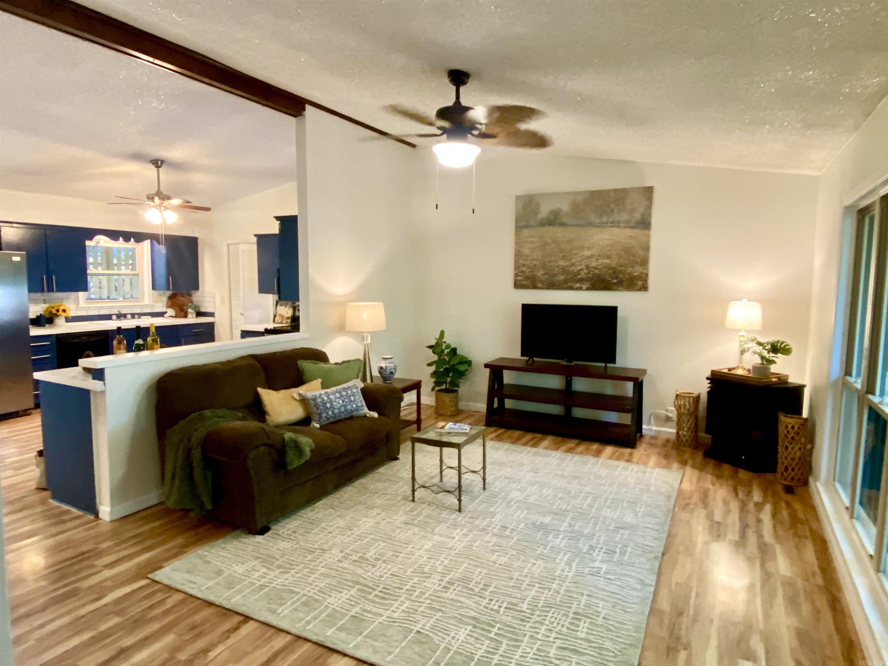 OPEN HOUSE SUN 12-2pm! BEAUTIFUL Mid-Century Modern home with soaring ceilings, an OPEN FLOOR PLAN and fresh new paint throughout! Ready for you to move in and enjoy.... the huge kitchen and living room lead to sliding glass doors into the lush backyard, complete with a patio to host your friends, plus all new Cedar Fencing with convenient gates on both sides. Inside, you'll appreciate the updated bathroom with a lovely glass-doored shower, a spacious primary bedroom with an en-suite, beautiful and durable vinyl flooring, a corner movable gas fireplace for cozy winter nights in the living room, and energy efficient newer vinyl windows throughout.  There's a laundry room off the kitchen, and a one-car garage with a large walk-in storage closet.  Let's talk about LOW MAINTENENCE....NEW ROOF, NEW FENCE, NEW HVAC, NEW HOT WATER TANK, NEW PAINT, newer model VINYL WINDOWS that flip in for easy cleaning, plus a NEW SHOWER. Seller did all this work, then needed to move back north to be near family. GRAB THIS AMAZING HOME NOW, before it's gone!