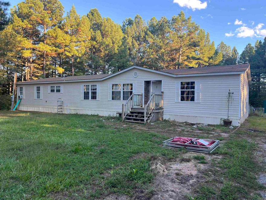 Lots of potential.  Great location.  Double wide mobile home built in 2008 is  on 2.26(+/-)  acres in a cut-de-sac. Guy public schools.    Home is sold as is where is.  See showing remarks