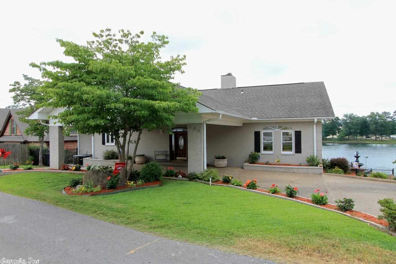 Offering fantastic Lake Hamilton views from its main channel location, this beautiful four bedroom, four bath home has been updated and manicured to "near-new" condition!  The landscaping is spectacular with a lake sprinkler system, lakeside flagstone patio, two covered decks, double boat dock with lifts, and gorgeous flagstone terracing.  There is a double portico at the entry, a double garage and a storage garage. Owner/Agent