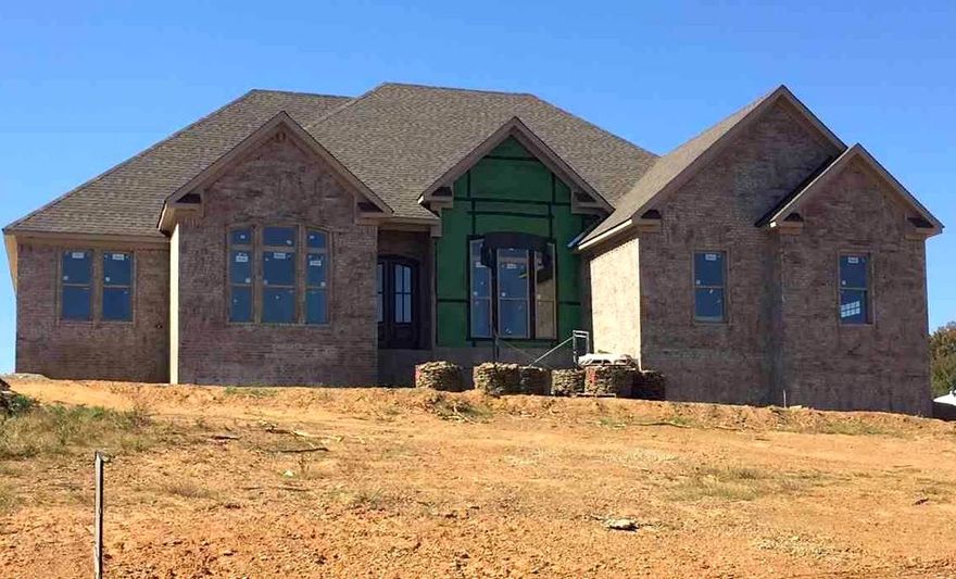 Awesome house, split plan, cherry rustic wood cabinets 9, 10, 11, 13 ft ceilings throughout,. quality build, energy efficient, brick and rock, granite, hardwood floors, living room with cozy fireplace.