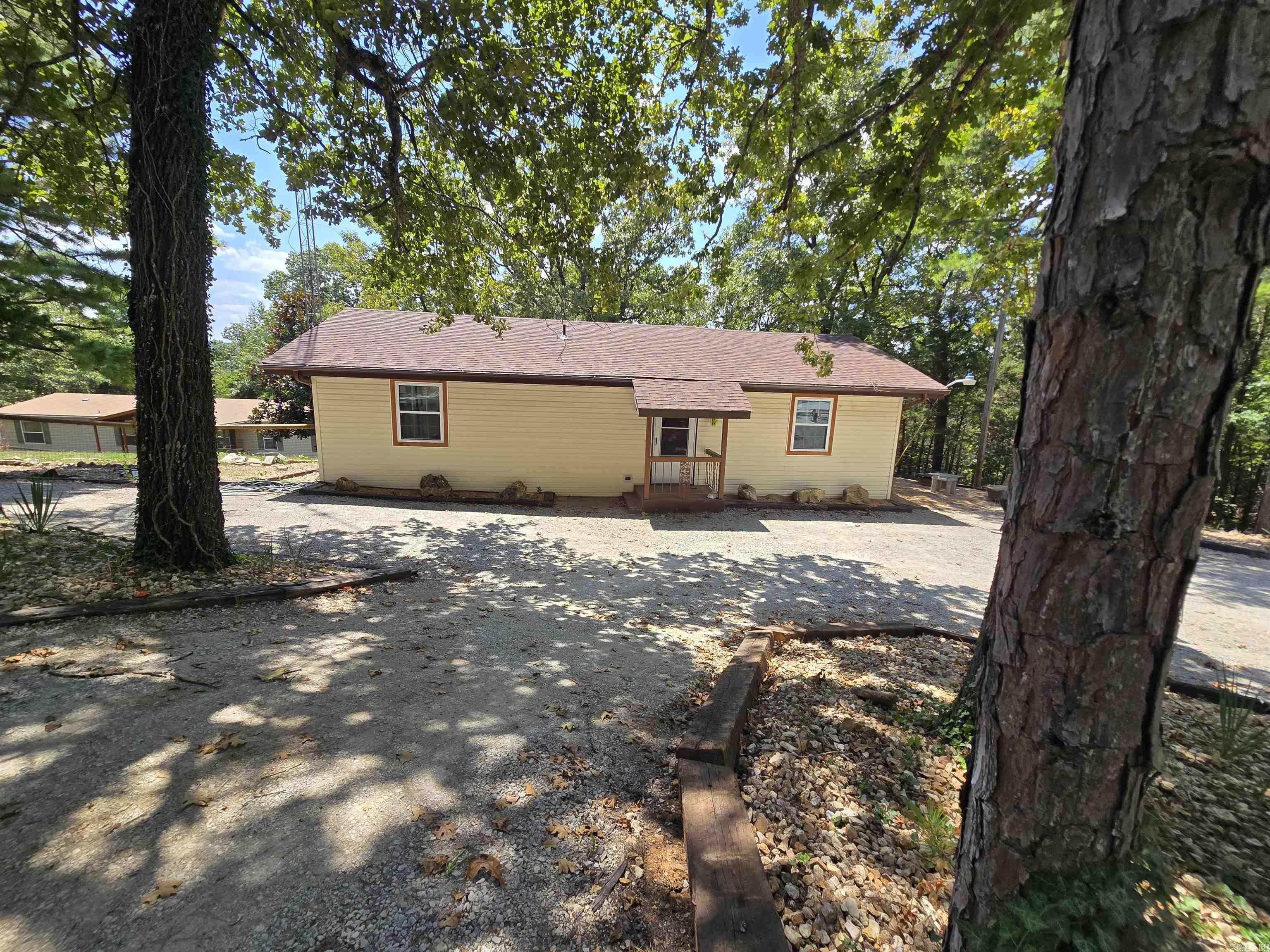 Two homes on nearly 7 acres m/l! The charming main home features 3 bedrooms, 2 bathrooms, a partial basement, and a workshop—plus a screened-in porch overlooking the spacious backyard. The guest home is a 4-bedroom, 2-bath manufactured home on a permanent foundation, perfect for extended family, rental income, or extra space. Enjoy peaceful country living with modern updates, including a brand-new well and a roof that's less than a year old. The 6.98-acre m/l property offers privacy, open space, and endless potential for gardening, hobbies, or outdoor fun. Located near Lake Norfork and Pigeon Creek for boating, fishing, and recreation. This is an ideal setup for multi-generational living or investment opportunities. Don't miss this rare find—two homes, acreage, and natural beauty for just $449,999!