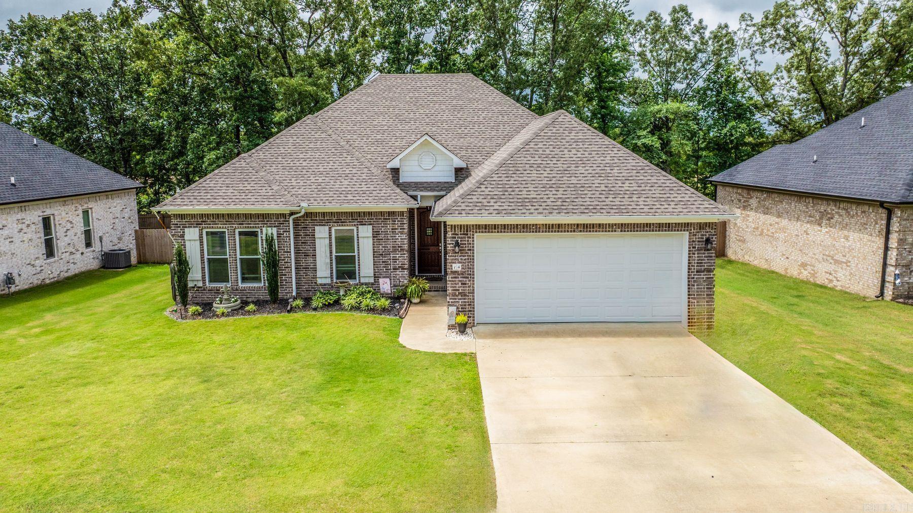 Better than New Construction!! Welcome to 14 Ridge View Street in Vilonia, AR! This beautiful 3 bedroom, 2 bath brick home offers 1,815 sq ft of comfortable living space and thoughtful design. Step inside to find an open concept layout with a spacious living area, stainless steel appliances, and a large island perfect for meal prep or entertaining. This has many energy efficient features including a 16 SEER HVAC unit, and low-E windows. The home features a separate laundry room, walk-in closets, and a generously sized primary suite with a luxurious bath including a soaking tub, double sinks, and separate shower. Enjoy mornings or evenings on the covered back porch overlooking a landscaped yard complete with a storage shed for extra space. The two-car garage adds convenience, while the curb appeal and well-kept surroundings make this home move-in ready. Located in a quiet neighborhood, this home offers a peaceful lifestyle with modern amenities and functional space both inside and out. Come see what makes this one a standout in Vilonia!