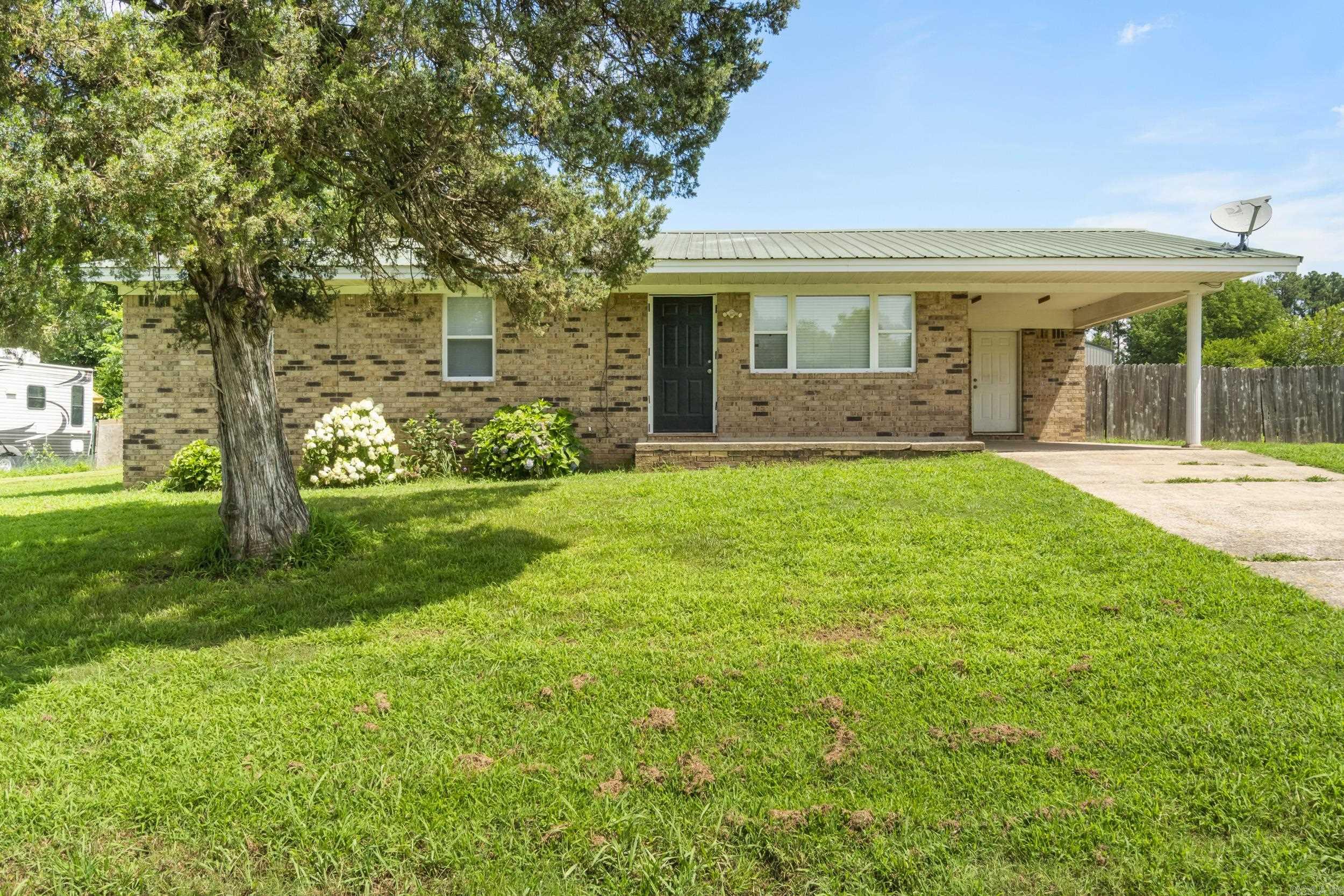 Welcome Home! This charming 3-bedroom, 1-bathroom home sits on a peaceful half-acre lot outside the city limits, offering the kind of quiet comfort and space thatās getting harder to find. Built on a slab foundation, this home offers a functional layout filled with natural light and large fenced-in backyard. With a welcoming layout, cozy living space, and thoughtful updates throughout, itās move-in ready and waiting for you! New updates are new luxury vinyl plank flooring in majority of the home, fresh paint, nice light fixtures, brand-new hot water heater, and more. Simple yet stylish, the kitchen offers just the right blend of comfort and convenience for everyday living. Outside, youāll love the convenience of the carport, plus a storage shed for all your tools and toys. Thereās plenty of space to garden, play, or simply soak in the slower pace of life. HVAC (2021) Metal Roof (2013) All windows were replaced by previous owners and are energy efficient. This home has been cared for and is move-in ready - just waiting for someone to make it their own. Come experience the quiet charm this place has to offer!