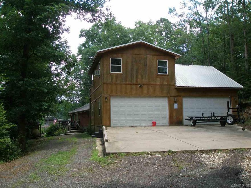 Lake living at its finest, new 2012 (4) car 40'x30' garage with 800 sf party room, full bath and bar, metal roof, second story door opens onto 10'x20' deck with lake view. (2) Lot has +/-100' lake frontage, covered boat &swim dock; main house has 3 beds, 2 baths, den, dining and kitchen, screened porch & deck. All electric except propane heat in garage apartment, city water, new septic 2006, HVAC 11/12, arch. roof October '10, wood burning stove, shop sink, appliances, & pool table convey. Boat negotiable.