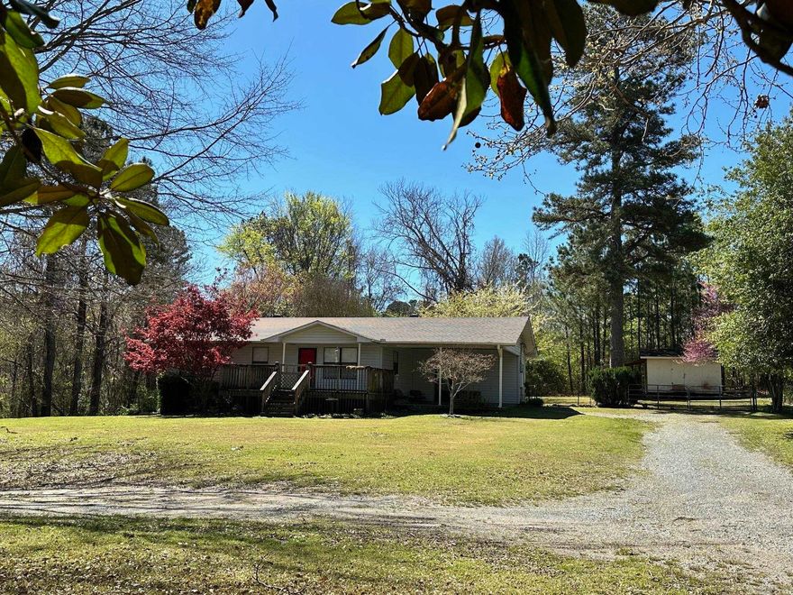 Welcome to your serene country oasis not far from Little Rock amenities and approx. 3 miles to interstate 530. This charming home is nestled on a beautiful acre adorned with a variety of flowering trees and shrubs and has a circle driveway leading to a convenient attached carport with a side entry. Inside, you'll find a welcoming interior design to cater to your comfort and needs with 3 bedrooms and 2 bathrooms. The kitchen and dining area flows seamlessly into the living room. The kitchen is equipped with a breakfast bar, ample pantry space, and stainless steel appliances. Off of the dining area is a large laundry room with extra storage and the primary bedroom is complete with a private bathroom.  Outdoor living is a dream here, with a deck off of the living room and a patio in the fenced backyard, perfect for entertaining or simply soaking in the serene surroundings. And, a shed with lean-to complements your storage needs. New roof and gutters Feb. 2022.  Contact agent for additional information and to schedule your appointment.