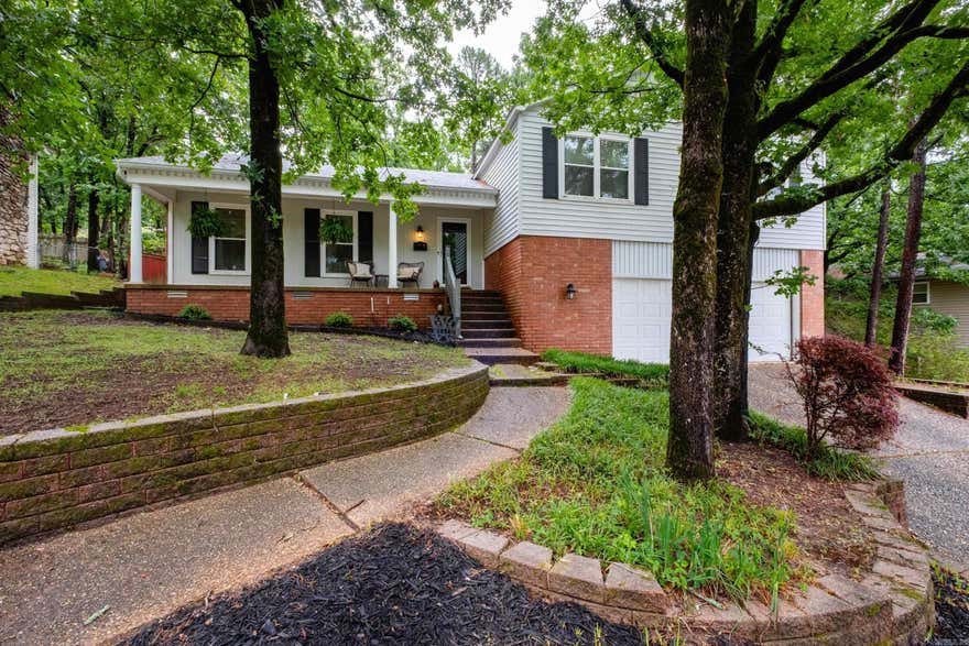 4 Bedroom 2 1/2 Bath home + 2 living areas in Mid-Town neighborhood. Wood flooring in Living Room, Kitchen - Dining Room.  Large open kitchen with work island / breakfast bar. Refrigerator (2023), dishwasher, gas surface range, vent-hood, wall oven (2023) & microwave. Built-in desk in kitchen. Step out to the deck from the kitchen. Few steps to den downstairs w/ wood floor, fireplace w/ gas logs & brick face & hearth with bookshelves built-in on each side of fireplace.  Wood beams accent the den which includes a wet bar with under counter refrigerator. Access to backyard from den. 1/2 bath off the den. (TV in den excluded - mount remains). Upstairs offers 4 nicd-size bedrooms and 2 full baths. 2 closets in primary bedroom. Updated primary bath (2017) with tiled walk-in shower.. White tile tub surround in hall bath, Toilets replaced 2023. Roof 2019 (per previous owner). Water heater 2023. HVAC downstairs 2025.  Convenient location to UAMS. Leawood pool & park located at 8723 Evergreen is available with voluntary membership fee. https://www.leawoodpool.org for information.  Seller relocating to NW Ark for job. Possession mid-July. (Need 1 hour notice to show please to remove pet)