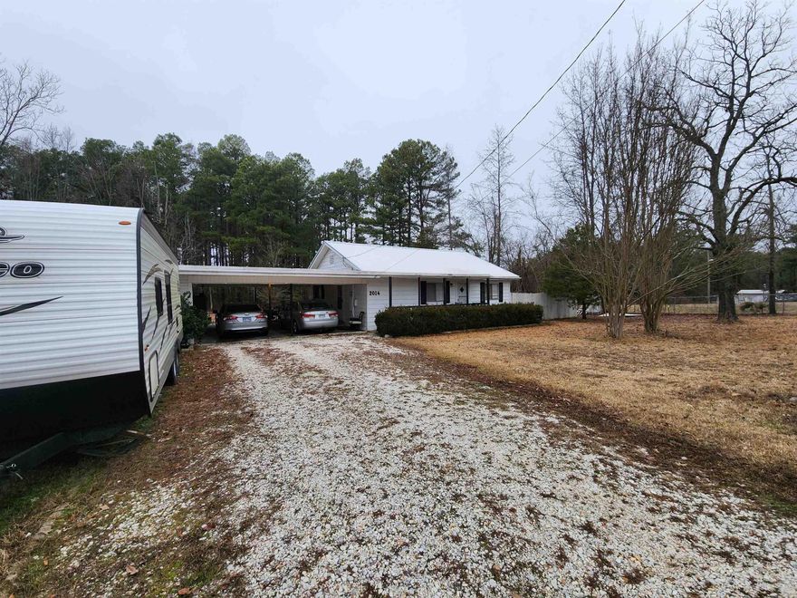 Cozy 2 bedroom home on 5 acres with lots of potential. Home had new paint, new floors & a metal roof put on in 2022, including newer HVAC. 2 car carport comes with tons of storage space! Appliances will convey. Property also has mobile home hookups near the shop that has electricity as well. You can find 3 beautiful pecan trees beside the storage area. Call for your tour today!