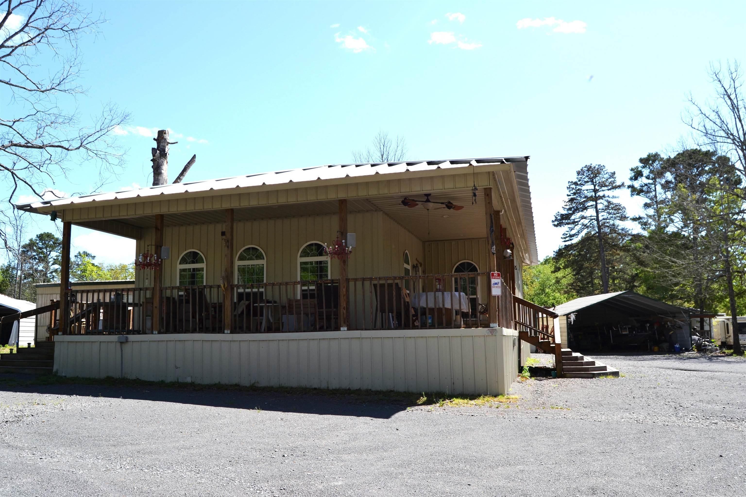 Location! Location! This property is less than a mile to Sugarloaf Marina and located in a great neighborhood. With the 20x30 new addition that was built in 2019 you can comfortably sleep a large family. The original mobile was a 2 bedroom, 2 bath and now includes large living area and a craft room. The deck is 30x30 and is completely covered for your enjoyment. New metal roof was added to cover everything in 2022. Situated on 2 lots, there is plenty of space for parking and also 2 storage areas for your lake toys. Call for your showing before boating season is here!!