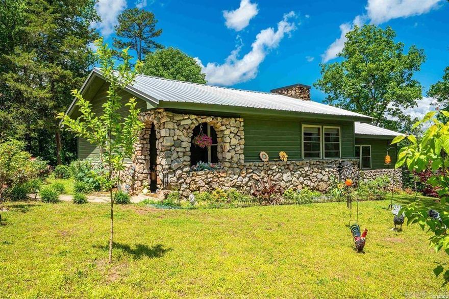 Escape to serenity in this beautifully remodeled 3-bed, 2-bath retreat on approximately 1 acre! Overlooking the tranquil waters of Lake Hamilton, this home has a perfect blend of rustic charm and comfort. Completely renovated in 2022, it features a metal roof, new insulation, flooring, cabinets, and windows. Enjoy the convenience of a staying refrigerator and new Bosch dishwasher. The storm cellar provides added peace of mind, and the concrete patio above it is perfect for taking in the surroundings. Surrounded by tall trees and nestled in a quiet area, this home feels like a cozy cabin getaway. Make it yours and start creating memories!