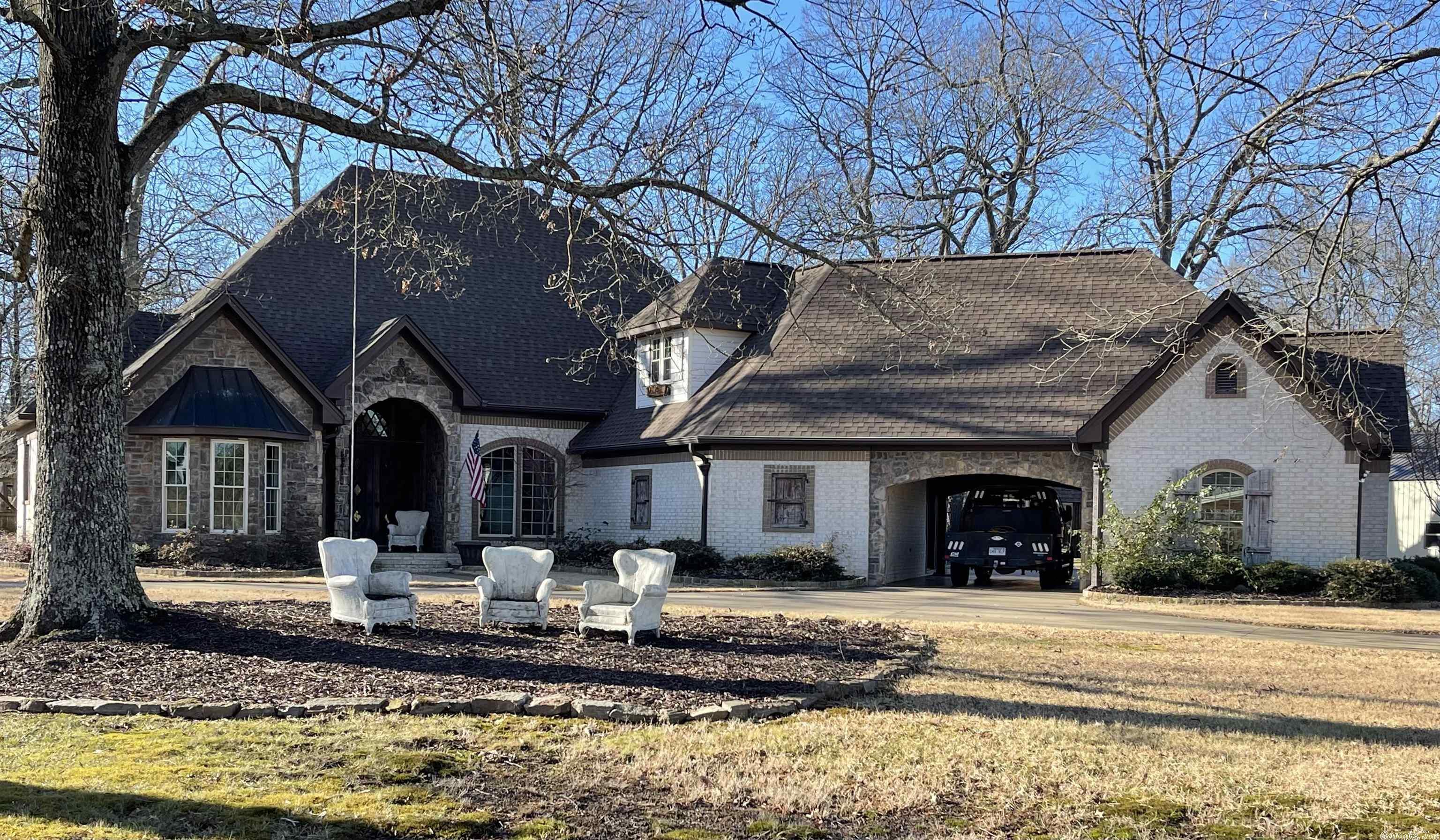 Beautiful secluded home on 40 acres! If you are looking for privacy with electronic gate entry and property fenced..you have found your dream home. 4 BR and 3.5 bath. Office, Dining Room, Den, Sunroom, Master and 2 additional BR's on main level and one MIL quarters upstairs. 2 separate garages with pull through portico. Safe room. Swimming Pool with guest house. Outside entertaining area. 30x30 shop. Entertaining barn with fireplace, fridge and is heated and cooled. This property has it all! See remarks!