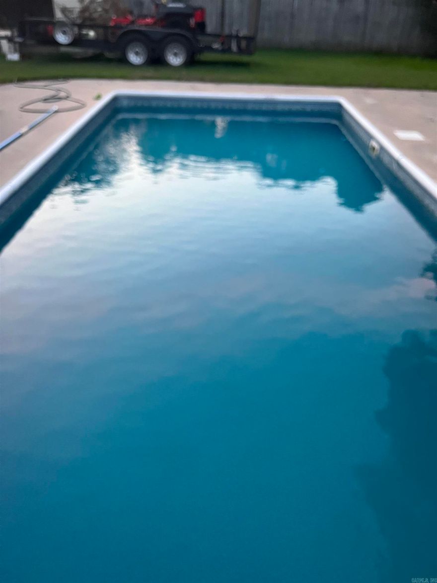 Charming 3-Bedroom Ranch with Relaxing Pool & Architectural Flair Welcome to 213 S Adcock St—a beautifully maintained, low-maintenance brick and siding home nestled on a level ¼-acre Oak Park lot. This open-concept ranch features 3 spacious bedrooms and 2½ baths across 1,590 sq ft.Vinyl floors, a cozy gas log fireplace, and a well-appointed breakfast bar set the stage for comfortable living. Unique architectural touches like the bi-level bedrooms and cathedral ceilings add character and spaciousness, while ia french door and ceiling fans enhance energy efficiency and comfort. Step outside to your private backyard oasis: a gently deep pool ideal for relaxation, a sturdy privacy fence, and a handy storage building. A welcoming front porch completes this delightful home—perfect for quiet mornings or evening sunsets.