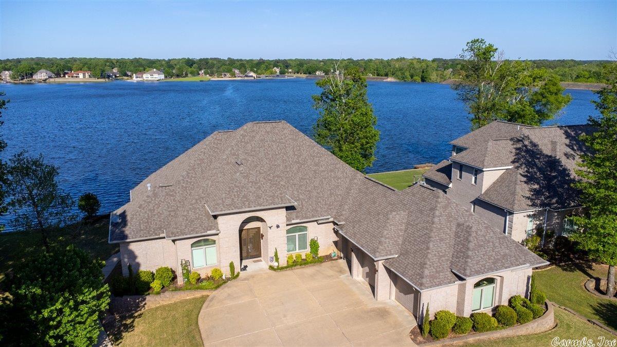 Immaculate Lake Front property with breathtaking views of Hurricane Lake from every room! Stunning formal living room with Brazilian teak hardwoods and large windows opens to grand wrap around outdoor deck which features surround sound, water, and gas line for outdoor cooking. Spacious Chef's Kitchen includes double ovens, warming drawer, convection microwave, gas range, walk-in pantry and opens to a beautiful hearth room with fireplace, breakfast area, and formal dining room. Primary suite features double tray ceiling, fireplace, sitting area, massive walk or roll-in shower, large closet with pull down rods, and double vanities. VERY energy efficient due to ICF Construction...call for utility statements because they are mindblowingly low! Some of the upgrades include elevator, whole home generator, EZ floating boat dock, whole house water filtration, HUGE FEMA approved safe room, storage galore, sprinkler system and more. Beautiful level backyard with boat dock and retaining wall. Quality and care were put into every inch of this exquisite property!