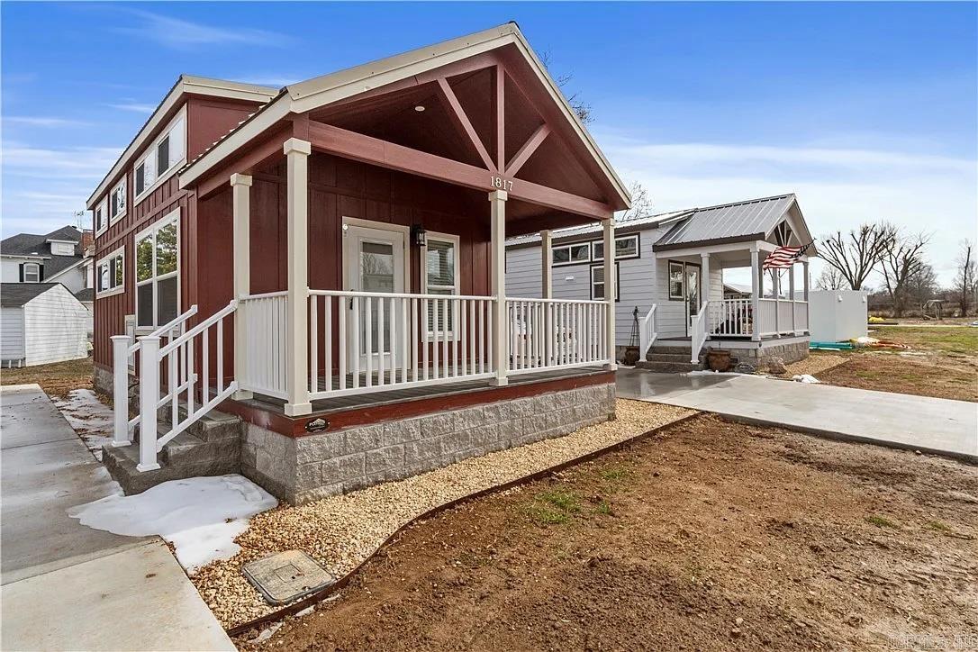 Move-in ready one-owner tiny home in the heart of Rogers! Built by Platinum Cottages, this thoughtfully designed 1-bedroom home with loft offers comfort, style, and simplicity—without the upkeep. Enjoy a full bath with walk-in shower, an open kitchen with full-size appliances, GE stack washer/dryer, and generous storage throughout. Quality construction includes a permanent concrete block foundation, Hardie-Board siding, durable metal roof, and double-pane windows for lasting efficiency. High ceilings, abundant natural light, LED lighting, and a dual split-system HVAC create an energy-efficient living space year-round. This home also comes with a 12' x 12' Tuff Shed utility building (144 sq ft) on a stainless steel riser and a fenced yard with black metal panels. Lawn care is included (fenced area excluded). The well-kept Eagle Homes on Monte Ne neighborhood is perfect for those looking to downsize or embrace a minimalist lifestyle. Prime location—walking distance to Veterans Park and minutes from shopping, dining, downtown Rogers, Walmart Headquarters, and Crystal Bridges Museum. Homes must be owner-occupied.