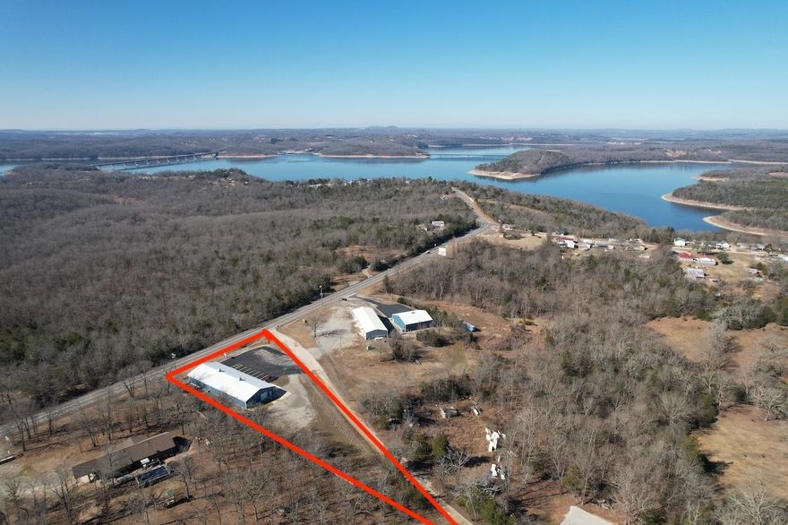 Commercial Opportunity in Henderson AR close to Norfork Lake and Mountain Home AR. The property has frontage on highway 62/412 and is approximately 1 mile to the Henderson Bridge over Norfork Lake. There is a well, septic system and electric service, high chain link in the back.  The building is 50x130 or 6500 sq ft, 2x6 wood framed with spray foam insulation it has zoned HVAC with 2 heat pump units. Formerly a Jet Ski dealer, it has a 5000 sq ft show room with 3 offices, 2 public rest rooms a service desk all nicely finished out with Pine and tin. Storage room, employee restroom and large shop area finished in white metal, air compressor and lift included the shop has garage door entry to both the show room and outside security fenced lot. 3 lighted signs and large paved parking area. It sits on approximately 1.83 acres. Owner financing is available for qualified applicants, more land with more buildings available.