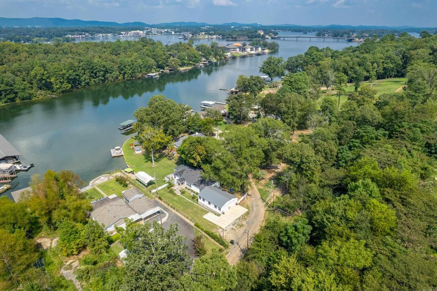 Lakefront living at its best! Discover this beautiful lakefront home featuring a private boat launch, boat slip with a swim deck, and a spacious covered porch overlooking a peaceful cove. With plenty of outdoor space, it's the perfect spot for relaxing or entertaining by the water. Tucked away on a quiet street with only six other homes, you'll enjoy both privacy and serenity. This property also includes an additional lot across the street-- an excellent opportunity for a tiny home, guest house, or additional investment, all with lake views. This home can be purchased fully furnished with an acceptable offer and could serve as a wonderful primary residence, vacation home, or an income producing short term rental-comfortably sleeping 8-12 guests. No permit is required since it's outside city limits, yet you'll still be just minutes from restaurants and grocery store for added convenience. Call today to schedule your showing!
