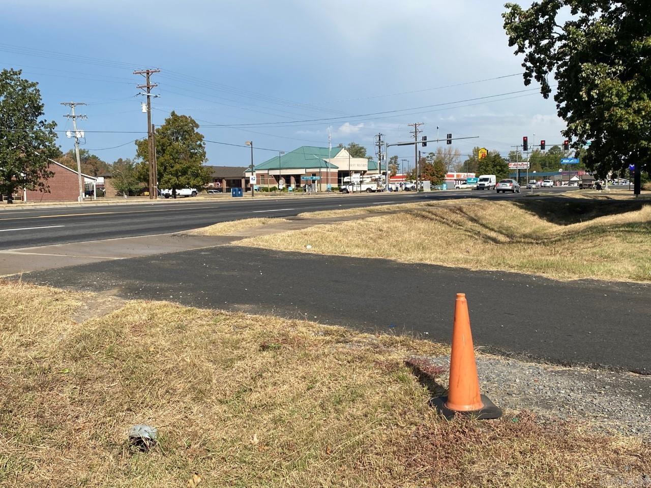 Great location!! Located adjacent to US 65 in a high traveled area. Across the Street from Post Office, Wal-Mart etc. Top part of property is level and then slopes down in back. Electricity, 2 Water meters, and Sewer on property. Two spots set up for vendors with electricity and water. One with sewer.