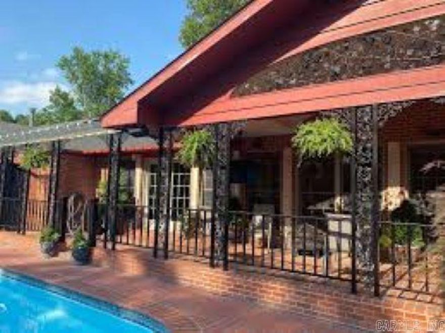 This property was custom built by the original owner and includes amenities galore. The main house holds 3 bedrooms and 2 full baths. The primary bedroom's en suite maintains a custom tiled shower, jetted self drying and self cleaning tub, marble countertop and custom cabinets.  The Gilmore custom kitchen is complete with sub zero refrigerator, China cabinets and more. The hardwood floored living room is large, contains a built in show cabinet and gas log fireplace. The attached apartment is approx +-1800 sq. ft. with bedroom, living and dining area, separate kitchen and laundry area. There is also a large closet with cedar closet, soaking tub and more.  Don't forget to check out the storm room, built in hallway bookcases, craft room and the pool and its gardens. The current owners use this property as a short term rental and will entertain offers for the purchase of all furniture and other staples. This property has more than meets the eye. Remodeled to meet today's tastes. Short term rental financials are available.