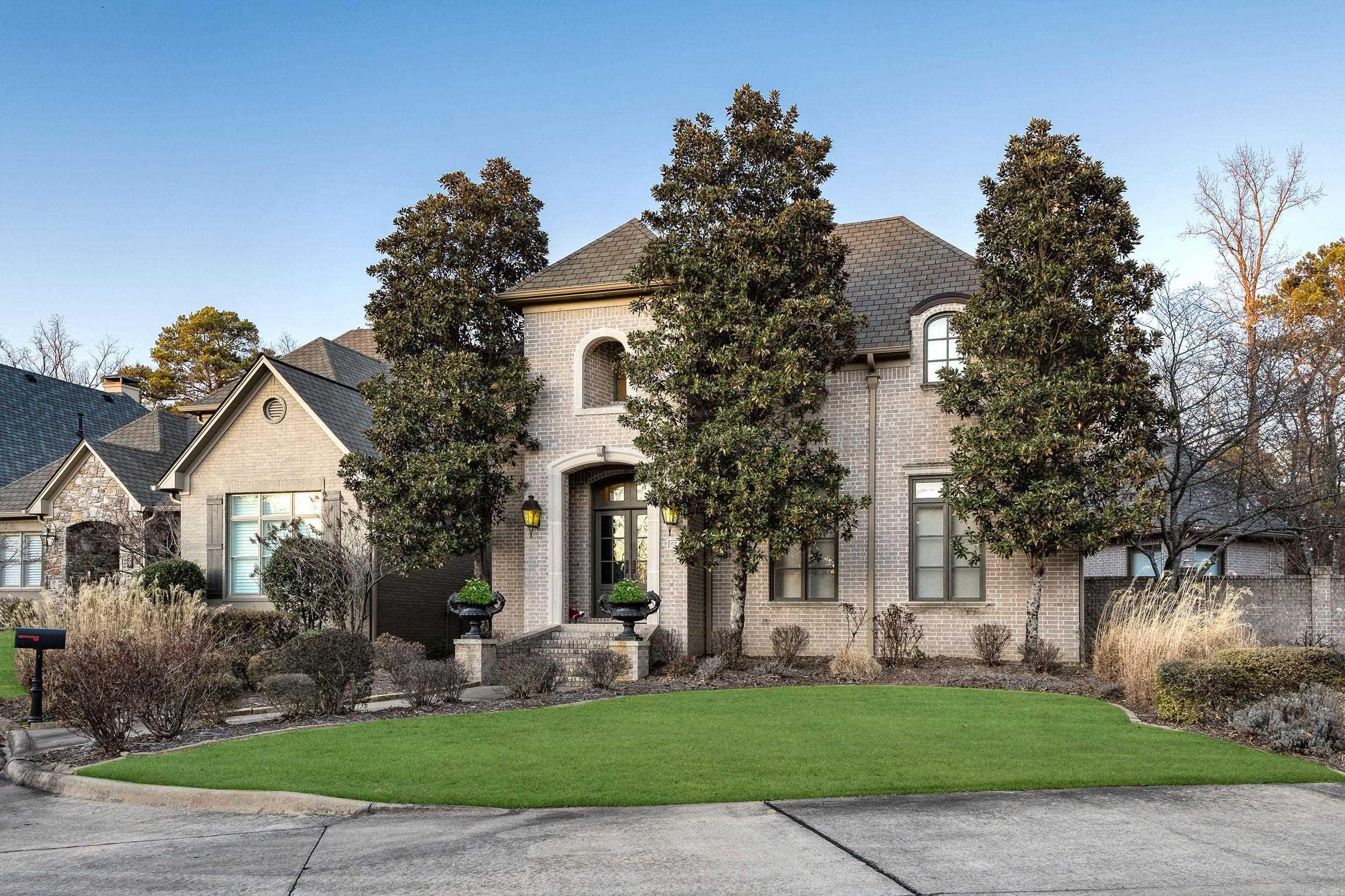 Nestled in the exclusive gated neighborhood of Chenal Valley "The Oaks," this classic 3 BR/2.5 BA home exudes timeless elegance and exceptional design. The main level features a spacious primary suite with large bath including a new shower with dual shower heads and an expansive closet with built-ins. Work from home in the stylish office with built-ins and two work areas. The chef of the home will enjoy the large kitchen with island including a 5 burner induction cooktop, double ovens, built in refrigerator, ice-maker, and wine cooler. The large great room showcases a gas fireplace and custom built-ins. Recent upgrades include new flooring, drapes, and roll-up blinds. The dining room impresses with an 18' ceiling with wood beams. Ascend the unique iron staircase to find 2BR and a bath. Every room offers a view of the private courtyard, perfect for relaxation and entertainment. The rear entry garage and golf cart garage will be a favorite feature. Experience luxury living at its finest at 57 Quercus Circle.