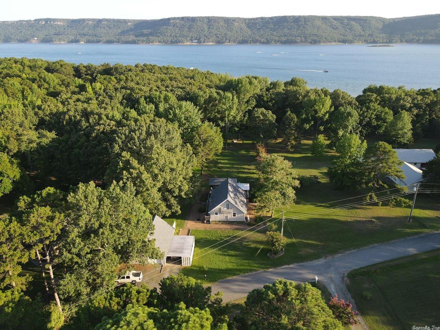 Beautiful tri-level on Greers Ferry Lake. 3 bed 2.5 bath with large downstairs living area with fireplace and walkout to the backyard. Covered outdoor kitchen with ceiling fans, gas hook-up and shades. Upstairs room has its own half bath with small balcony for enjoying your morning coffee. HUGE backyard with fenced area with a nice chain-link.Brand new flooring downstairs, brand new water heater and 3 new/separate air conditioning units. All new in '21/'22  Currently being rented on AirBnB for $240/night. Option to purchase fully furnished!   Water/lake front Only 3 minutes to Shilo Marina.