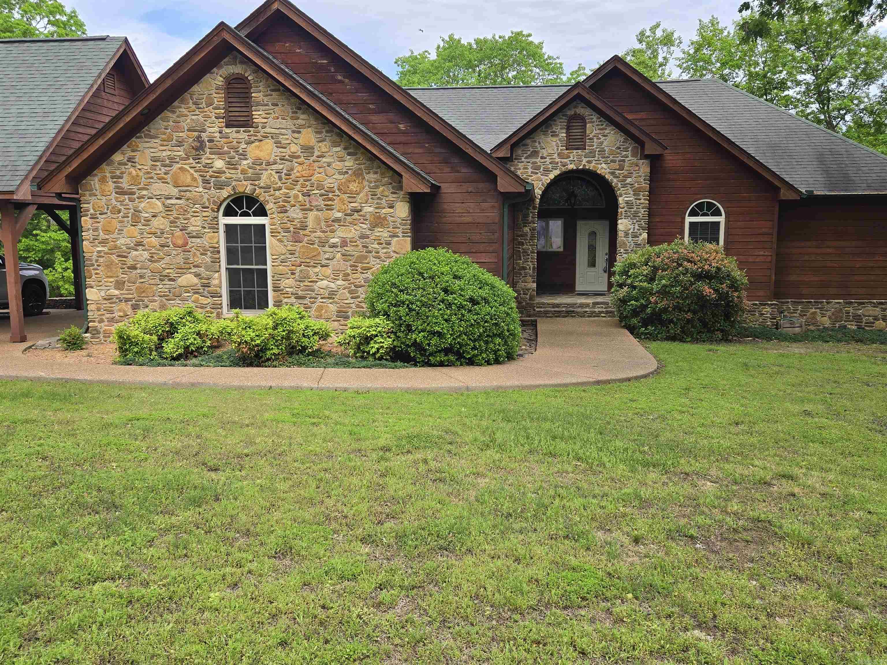 Fantastic Lakefront home. Right on the water with four bedrooms, four bathrooms, Private two slip boat dock with one lift and with solar power. Two car garage, three car carport. Wet Bar tons of room for pool table. media room. Rock steps out the back down to the dock. Covered back deck for outdoor cooking and enjoying life. Hop in your boat and cruise out to a 40-thousand-acre Lake. Plenty of golf courses, 90 miles of ATV Trails. Fairfield Bay Marina is only 3 miles away. Plus, plenty of fishing right off the dock. RV pad for those who like to travel. Everything is here to bring your family and friends to have a great time away from it all. Very quiet and seclude area. Mostly retired couples and summer homes in this area. There are hardwood floors upstairs and crown molding in every room plus stamped concrete on the patio. The outside carport could be closed in for three garages. No HOA fees. House next to the Lake with your own private two slip Dock is really hard to find. Don't let this one get away. There are steps down to the Boat Dock. Perfect setup. Sellers are MOTIVATED!!!
