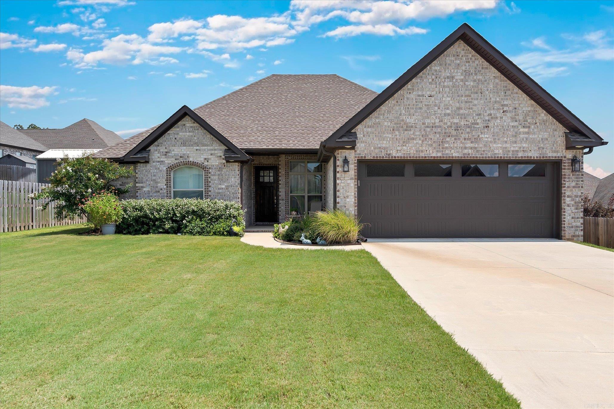 Welcome to 3600 Jaxon Lane. This is a well-maintained, energy-efficient home that blends comfort, style, and beautifully designed landscaping to create the perfect retreat. Step inside this 4-bedroom split floor plan and you will find inviting spaces filled with thoughtful touches. The living room features a propane fireplace, luxury vinyl plank flooring, and a warm, welcoming atmosphere. The kitchen is both stylish and functional, with quartz countertops, a wall oven, built-in microwave, walk-in pantry, and easy-to-clean windows. The refrigerator, washer, dryer, and even the living room TV all stay, making your move-in effortless. The private primary suite offers a spa-like escape with a stand-alone tiled shower, relaxing soaker tub, and a spacious walk-in closet. Three additional bedrooms also feature walk-in closets for plenty of storage. Enjoy your mornings in the screened back porch or entertain in the beautifully landscaped backyard. Perfectly located near shopping, medical facilities, and entertainment, this home also offers a dedicated laundry room, abundant storage, and an all-electric, energy-efficient design for low-maintenance living.
