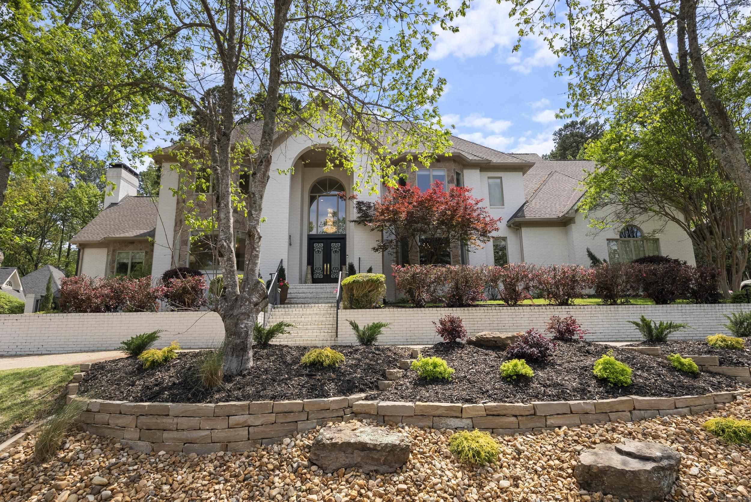 LUXURY awaits behind the 24/7 guarded gates of this prestigious and highly sought after Hickory Creek Home. Welcome your guest through the amazing custom iron and glass door. With a kitchen fit for a chef, you have a large island, ample storage, a walk in pantry and a view out the bay window to the fabulous backyard. Step out the door from the breakfast room to the large deck with outdoor BBQ and outdoor living at its finest. The large yard has plenty of room for a future pool or entertaining family and friends. Back inside you will find a formal study with built-in's and a separate formal dining with plenty of room for those family dinners and hosting parties! An evening by the fire in the large living room is the perfect place to settle down. The home provides a generous first floor bedroom suite with walk in shower and double glass doors leading to the garden room filled with natural light. Upstairs you will find a huge master suite, large walk in closets and a very nice master bathroom with garden tub and shower. There are also four more bedrooms and two full bathrooms. A massive floored attic space provides so much storage and the oversized three car garage is great!