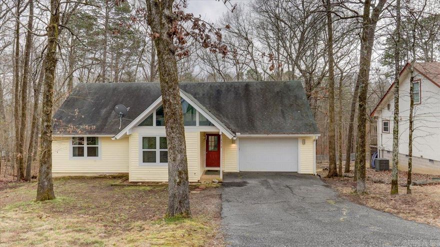 Bright and Cheerful home in Diamondhead Golf and Lakefront Gated community.  This just right sized home features an open floor plan in the living/dining/kitchen areas and 2 bedrooms/1 bath upstairs.  Oversized 3rd bedroom/den on the lower level with an updated bath and laundry.  Updated kitchen, flooring, fresh paint indoors and outdoors.  2 Car Garage opens to kitchen.  Great neighbors waiting to greet the new owners.     Two level deck overlooks a gorgeous back yard with woods behind (no neighbors).  Community includes Golf Course, Tennis Courts, Amenity Center, Marina, Water access, gated entrance and friendly folks.  Just 12 miles from everything that Hot Springs has to offer with fun, restaurants, shopping, entertainment, casino, hiking, biking and more.  Come see this home today!