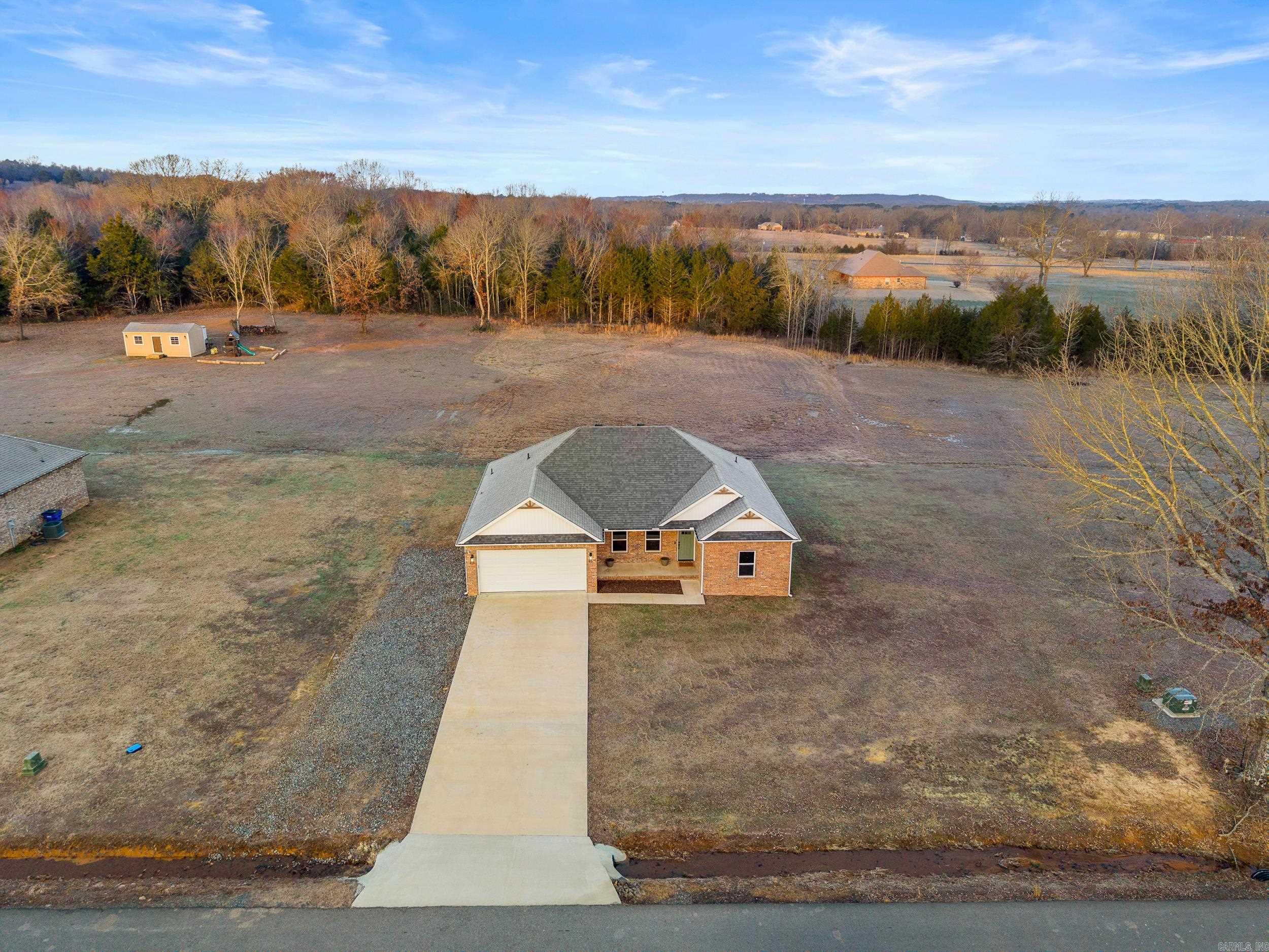 Gorgeous 4 bed, 2 bath home sitting on a full acre in the highly sought after Greenbrier School District! This stunning 2022 built, all-electric beauty offers the best of modern living with an open floor plan, gleaming granite countertops, and durable LVP flooring throughout. The split bedroom layout provides privacy, while the spacious master suite features a luxurious tiled shower. Outside, you'll find plenty of space to stretch out, plus a gravel parking pad alongside the driveway-perfect for extra vehicles. This home is a rare find that will not last long! AGENTS PLEASE SEE REMARKS
