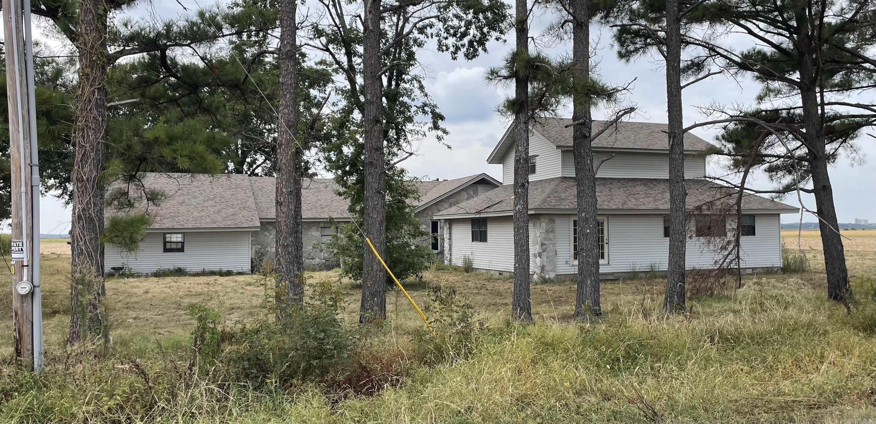 This home sits on 1.96 acres across from Fedex, East of city of Jonesboro. This home has a 3 car garage, 4067 square feet with two kitchen areas. Roof is newer and interior ceiling and walls appear to be in good shape. The floor joist along with subflooring and floor coverings need repaired or replaced.