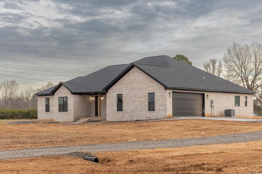 Sitting on 2.5 rural acres, this new construction is finishing completion! The open floor plan features 4 bedrooms and 2.5 bathrooms. The primary closet is connected to the laundry room! The bathrooms feature stunning tile work and the kitchen features an abundance of quartz countertops, cabinets and pantry! Enjoy looking out to the back of your property from your window above the kitchen sink. The floors are a natural LVP throughout. Cozy up next to the gas fireplace this winter and enjoy your rural view from your back porch! This home has natural gas and is on city sewer. This property is conveniently located between Russellville, Conway and Little Rock - with easy access to I-40. Enjoy living at the base of Petit Jean Mountain and hiking the trails in the state park on the weekend. *Fiber Internet Available Here* *Taxes were valued on vacant land and will increase.