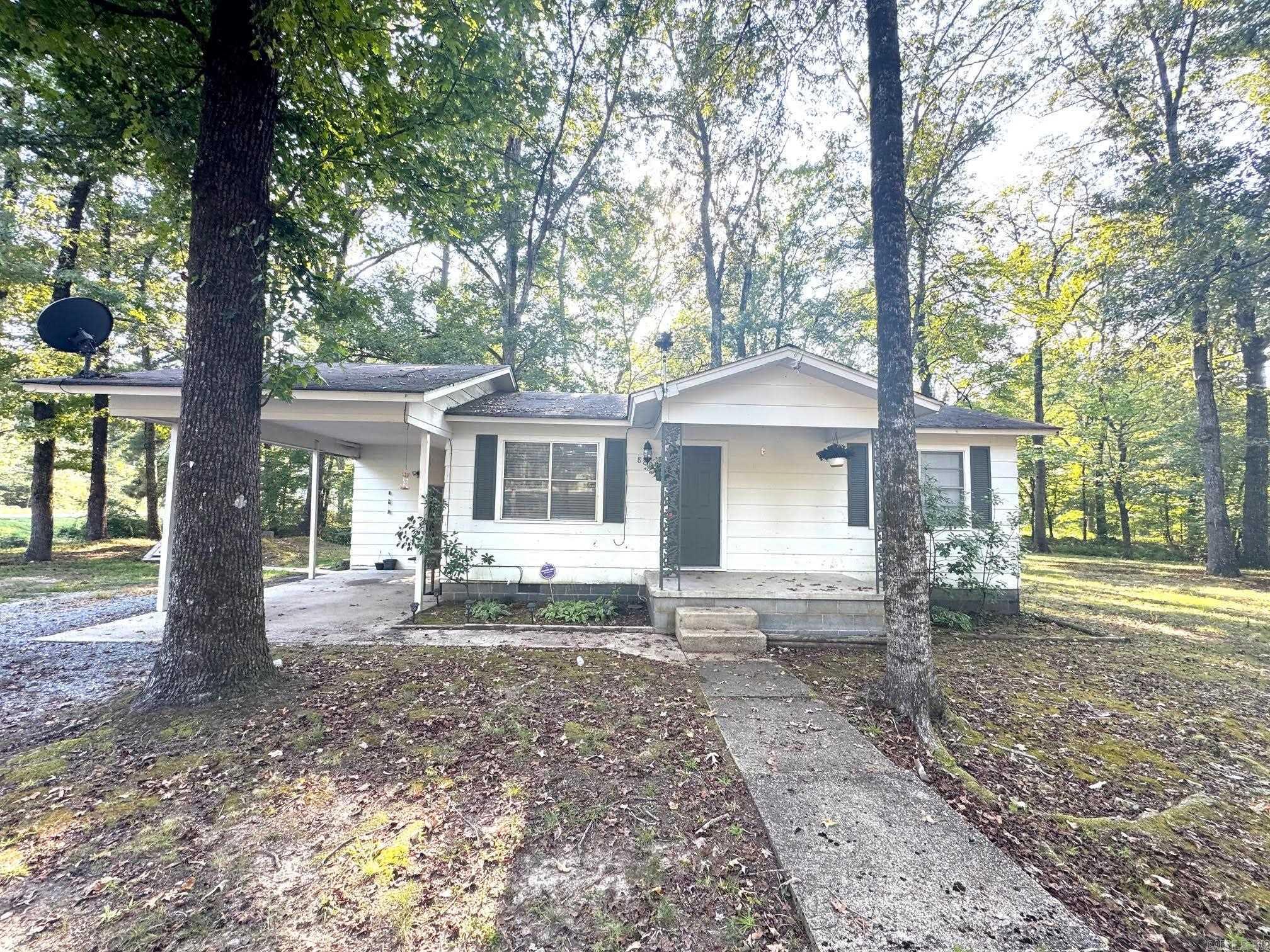 The home is 640?sq ft, with 2 bedrooms, 1 bathroom. Lot size is approximately 1 acre. Built in 1969. It’s a frame house, exterior is wood. Foundation: built on piers. There is combination of tile and carpet. No central cooling or heating systems listed (none specified).