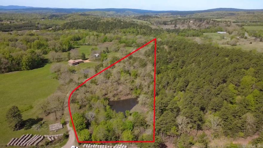Discover privacy and natural beauty with this 4.6-acre parcel! This mostly wooded property features an abundance of mature hardwoods, offering a serene setting ideal for a homesite, cabin, or recreational retreat.  A standout feature of the property is the nice stocked pond, providing both scenic value and enjoyment for fishing or relaxing by the water. Utilities are available at the road, making development convenient while still preserving the peaceful, rural atmosphere.  You'll enjoy beautiful mountain views to the south through the trees! Outdoor enthusiasts will appreciate the proximity to the Fourche LaFave River and the Ouachita National Forest, offering endless opportunities for hiking, fishing, hunting, and exploring.  This property provides flexibility for a variety of uses—whether you’re looking to build, invest, or create your own getaway.  Don’t miss this opportunity to own a piece of Arkansas’s natural beauty.