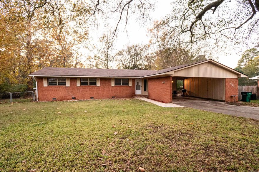 Charming brick home featuring 3 bedrooms, 2 baths, a cozy den, and a spacious backyard with a back deck located in the Racquet Club Subdivision.