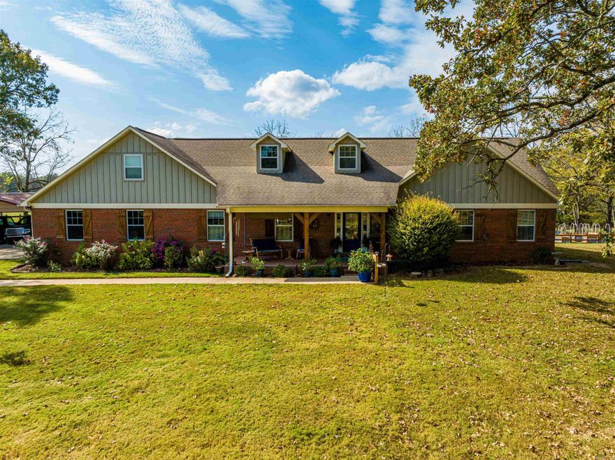 Nestled in the foothills of the Ozark Mountains and consists of 55 +/- rolling acres sitting on one of the highest hills in the county, which includes four ponds, all fenced and cross-fenced, ready for cattle, sheep, or goats, which will make this a beautiful Hobby Farm.The main residence is about 5,050 +/-sq ft under the roof and 3312 +/- sq ft heated and cooled, with 1230 +/- sq ft in the unfinished basement and 524 +/- sq ft in the garage.The vented heat pump system keeps the basement at a year-round moderate temperature.Second residence is a beautiful 1580 +/- sq ft Clayton double-wide mobile home with a new custom-built deck off the back, a fenced yard, and a built-in dog house under the back deckA private drive leads to this secondary home off the main drive, making it ideal for guests, family, or a rental. As you enter the property through a beautiful custom security gate with a keypad or automatic clicker, you are greeted with an 800’ landscaped driveway with board fencing (only two years old) leading to the main residence that overlooks the whole property from the front and back of house and views across the countryside.See additional information AND Floorplan!